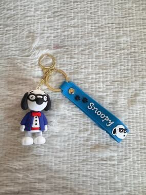 Snoopy suit and red bow tie keychain blue strap and white Snoopy face graphic